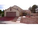 Charming two-story home with a well-manicured front yard and a spacious two-car garage at 9113 Anchor Cove Ct, Las Vegas, NV 89117