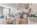Stylish kitchen featuring stainless steel appliances, a central island, and modern cabinetry at 9920 Ullom Dr # Lot 3, Las Vegas, NV 89141