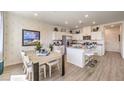 Modern kitchen with white cabinets, stainless steel appliances, and an island with seating at 9920 Ullom Dr # Lot 3, Las Vegas, NV 89141