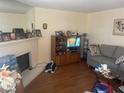 Comfortable living room with a fireplace, wooden floors, and a gray couch at 1112 Observation Dr # 102, Las Vegas, NV 89128