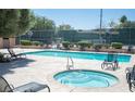 Community pool and spa with lounge chairs for sunny relaxation and outdoor enjoyment at 1455 E Katie Ave # 16, Las Vegas, NV 89119