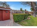 Charming single-story home with a well-manicured lawn and mature landscaping and a red tone at 1801 S 15Th St, Las Vegas, NV 89104