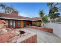 Inviting front patio with brick accents, rock water feature, and lush landscaping for outdoor enjoyment at 1801 S 15Th St, Las Vegas, NV 89104