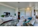 Spacious living room features a plush sofa, large windows, and a decorative rug at 2184 Tiger Willow Dr, Henderson, NV 89012