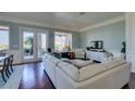 Bright living room with large windows, a comfortable sofa, and elegant decor at 2184 Tiger Willow Dr, Henderson, NV 89012