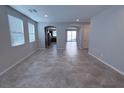 Bright living room features an open floor plan with modern tile floors at 22 Kaku Ridge Way, Las Vegas, NV 89183