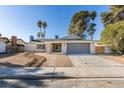 Charming single story home featuring desert landscaping, a two car garage, and neutral colored paint at 2205 Mccoig Ave, Las Vegas, NV 89119