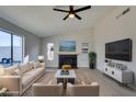 Bright living room features a fireplace, light wood floors, modern furniture, and large sliding glass door at 2205 Mccoig Ave, Las Vegas, NV 89119