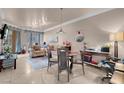 Open concept living area with modern lighting, tile flooring, and a cozy seating arrangement at 230 E Flamingo Rd # 115, Las Vegas, NV 89169