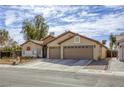 Inviting single-story home with a two-car garage, complemented by tasteful desert landscaping at 2625 Torch Ave, North Las Vegas, NV 89081