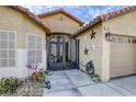 Close up front entry with an ornate security gate leading to an inviting entrance at 2625 Torch Ave, North Las Vegas, NV 89081