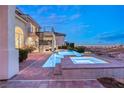 Luxury home features a stunning backyard pool, spa, and outdoor staircase with desert views at 2660 Mirabella St, Henderson, NV 89052