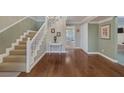 Grand foyer with hardwood floors, staircase, elegant decor, and an open view into the dining area at 3141 E Katie Ave, Las Vegas, NV 89121