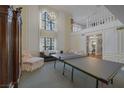 Bright living area with high ceilings, large windows, a chandelier, and vintage-style decor at 3141 E Katie Ave, Las Vegas, NV 89121