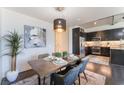 Cozy dining room with modern lighting, stylish table setting, and adjacent gourmet kitchen at 353 E Bonneville Ave # 746, Las Vegas, NV 89101