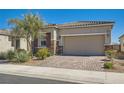 Single-story home boasts a brick driveway and desert landscaping for a clean, welcoming look at 4708 Mindful St, North Las Vegas, NV 89031
