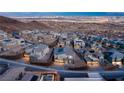 Stunning aerial view of a modern community showcasing stylish homes and well-maintained streets against a backdrop of city lights at 522 Riley Ridge Ct, Henderson, NV 89012