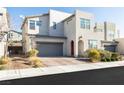 Two-story home featuring a two-car garage, desert landscaping, and modern design at 524 Grand Cascade Pl, North Las Vegas, NV 89084
