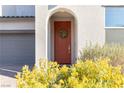 Close-up of the front door with a decorative wreath, surrounded by desert landscaping at 524 Grand Cascade Pl, North Las Vegas, NV 89084