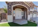 Inviting double front doors framed by stone archway and manicured green lawn at 6377 Elizabethtown Ave, Las Vegas, NV 89110
