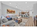 Inviting living room with a cozy couch, and an open floor plan to the kitchen at 6434 Spring Jog St, Las Vegas, NV 89166