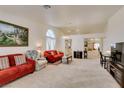 Spacious living room with vaulted ceilings, neutral carpet, and an open concept layout with plenty of natural light at 6574 Curacao Dr, Las Vegas, NV 89156