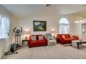 Bright and airy living room featuring neutral carpet, vaulted ceiling, and large windows at 6574 Curacao Dr, Las Vegas, NV 89156