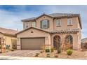 Inviting two-story home with a well-maintained front yard, covered entry, and an attached two-car garage at 6904 Baylor Creek St, North Las Vegas, NV 89086