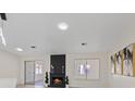 Bright living room with black brick fireplace, modern décor, and recessed lighting at 7138 Sixshooter Dr, Las Vegas, NV 89119