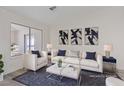Bright, staged living room with comfortable seating and modern decor at 7138 Sixshooter Dr, Las Vegas, NV 89119