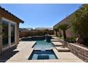 Backyard featuring a modern pool, stepped stone features, with mature landscaping at 7325 Rustic Crest St, Las Vegas, NV 89149