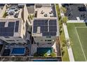 Aerial view of the modern home, rooftop deck, solar panels, and a luxurious swimming pool at 8116 Haywood Estate Ave, Las Vegas, NV 89113
