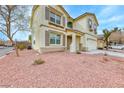 Close-up of home's exterior shows stucco, double-hung windows and xeriscaping at 9629 Grouse Grove Ave, Las Vegas, NV 89148