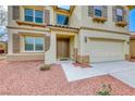 The home's entrance is framed by stucco columns; note the desert landscaping and two-car garage at 9629 Grouse Grove Ave, Las Vegas, NV 89148