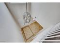 A modern light fixture hangs above an entry foyer with designer tile flooring and white trim at 9629 Grouse Grove Ave, Las Vegas, NV 89148
