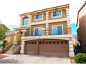 Two-story home featuring a balcony, a two-car garage and a landscaped front yard at 9739 Fox Estate St, Las Vegas, NV 89141