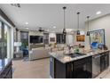 Bright, modern kitchen with breakfast bar overlooking the living area at 11283 Gravitation Dr, Las Vegas, NV 89135