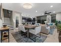 Open-concept living and dining area with hardwood floors and stylish furnishings at 11283 Gravitation Dr, Las Vegas, NV 89135