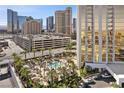 Well-maintained pool area with palm trees, lounge seating, landscaping, and convenient parking at 135 E Harmon Ave # 221, Las Vegas, NV 89109