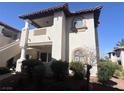 Charming condo featuring a second-story balcony, arched windows, and well-maintained landscaping at 1403 Santa Margarita St # D, Las Vegas, NV 89146