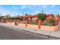 Charming single-story home featuring a secure metal gate and well-maintained lawn at 147 Cervantes St, Las Vegas, NV 89101