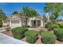 A charming single-story home with well-maintained landscaping and a cozy front porch at 2024 Riva Del Garda Pl, Las Vegas, NV 89134