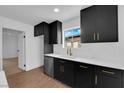 Updated kitchen showcases sleek black cabinets, stainless steel appliances, and a white subway tile backsplash at 2058 Citroen St, Las Vegas, NV 89142