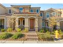 Inviting townhome entrance with a charming, covered entryway, tidy landscaping, and a welcoming front door at 2409 Bellinzona Pl, Henderson, NV 89044