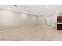 Spacious living room with neutral walls, tile floors, and ample natural light at 2409 Bellinzona Pl, Henderson, NV 89044
