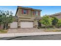 Charming two-story home with stone accents, a well-manicured lawn and three-car garage at 2583 Hazelburn Ave, Henderson, NV 89044