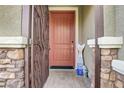 Welcoming entryway features decorative metal door, stone columns, and a cheerful 'welcome' sign at 2583 Hazelburn Ave, Henderson, NV 89044