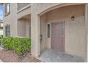 Covered condo entrance with security door and neutral-toned stucco at 3544 Desert Cliff St # 102, Las Vegas, NV 89129