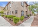 Condo exterior with manicured landscaping, walkway and neutral-toned stucco at 3544 Desert Cliff St # 102, Las Vegas, NV 89129