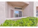 Condo patio with sliding glass door overlooking manicured landscaping at 3544 Desert Cliff St # 102, Las Vegas, NV 89129
